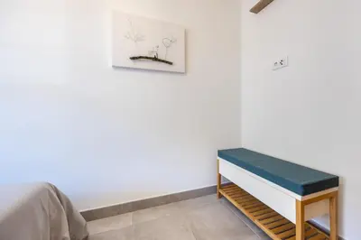 a room with a bed and a bench at Casa Memória in Vila do Bispo