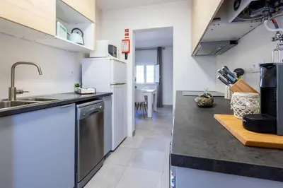 a kitchen with a sink and a refrigerator at Casa Memória in Vila do Bispo