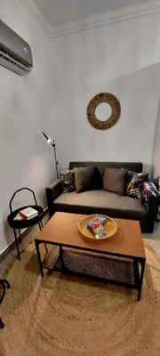 a living room with a couch and a table at Casa Papillon in Sagres