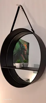 a black mirror hanging on a wall with two bowls at Casa Papillon in Sagres