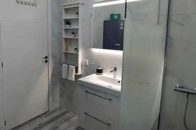 a white bathroom with a sink and a mirror at Casa Papillon in Sagres