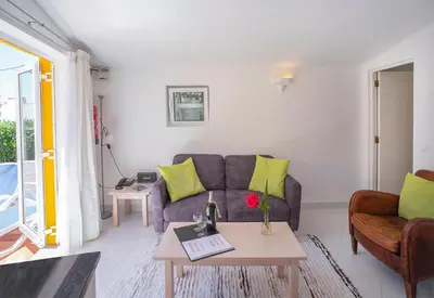 a living room with a couch and a table at 1 Bed Flat - Sleeps 2 - Pool - Parking - Wifi in Luz