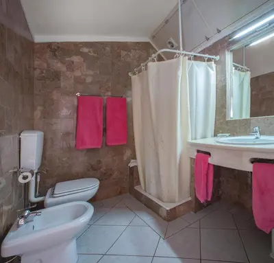 a bathroom with a toilet and a sink and a shower at 1 Bed Flat - Sleeps 2 - Pool - Parking - Wifi in Luz