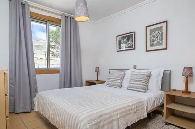 a bedroom with a white bed and a window at Casa Anaim by Homie in Porto Santo
