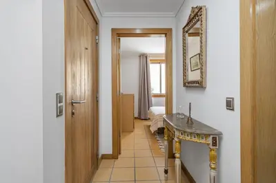 a hallway with a bathroom with a sink and a mirror at Casa Anaim by Homie in Porto Santo
