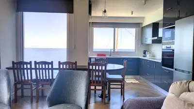 a kitchen and dining room with a table and chairs at Holiday`s House 