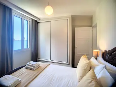 a bedroom with a bed and a window with towels on it at Holiday`s House 