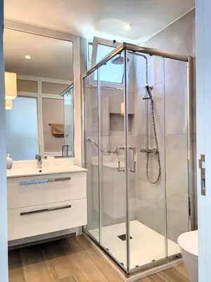 a bathroom with a shower with a glass door at Holiday`s House 