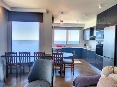 a kitchen and dining room with a view of the ocean at Holiday`s House 