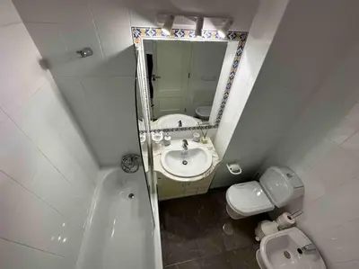 a bathroom with a sink and a toilet and a mirror at Casa Buccaneer, 2 Bedroom Garden Apartment in Praia da Luz in Luz