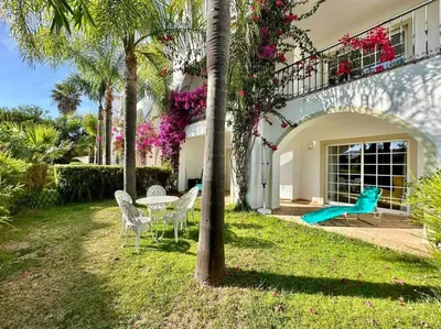 a house with a playground and a table and chairs at Casa Buccaneer, 2 Bedroom Garden Apartment in Praia da Luz in Luz