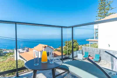 a view from the balcony of a house with a table and chairs at Casa Teixeira by Atlantic Holiday in Venda do Atalhinho