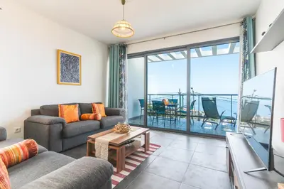 a living room with a couch and a table at Casa Teixeira by Atlantic Holiday in Venda do Atalhinho