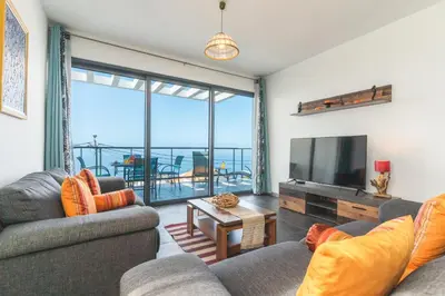 a living room with two couches and a flat screen tv at Casa Teixeira by Atlantic Holiday in Venda do Atalhinho