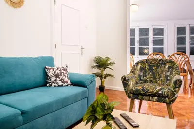 a living room with a blue couch and a chair at GuestReady - Blissful Getaway in Funchal in Funchal