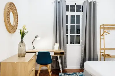 a bedroom with a desk and a bed and a window at GuestReady - Blissful Getaway in Funchal in Funchal