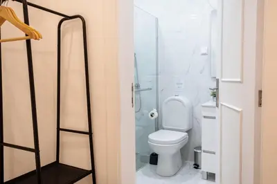 a bathroom with a toilet and a glass shower at GuestReady - Blissful Getaway in Funchal in Funchal