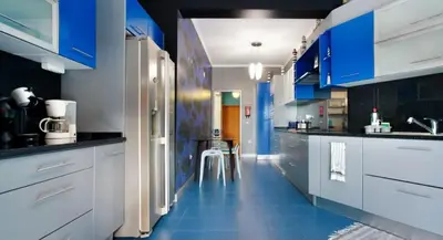 a kitchen with blue cabinets and a blue floor at O farol do funchal in Funchal