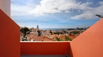 a view of the city from the balcony of a building at O farol do funchal in Funchal