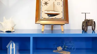 a blue shelf with a clock and other items on it at O farol do funchal in Funchal