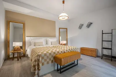 a bedroom with a large bed with a yellow and white blanket at Northern Secret by Homie in Ponta Delgada