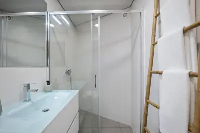 a white bathroom with a sink and a shower at Northern Secret by Homie in Ponta Delgada