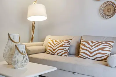 a living room with a couch with zebra pillows at Northern Secret by Homie in Ponta Delgada