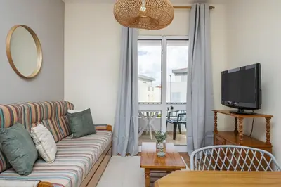 a living room with a couch and a tv at Escapadinha do Sol by Homie in Porto Santo