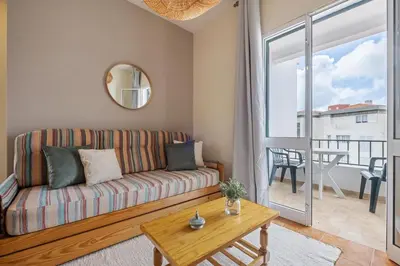a living room with a couch and a table at Escapadinha do Sol by Homie in Porto Santo