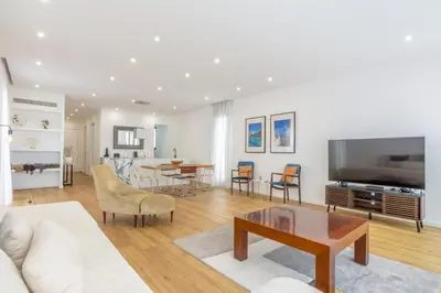 a living room with a couch and a table at Villa Mármore in Funchal