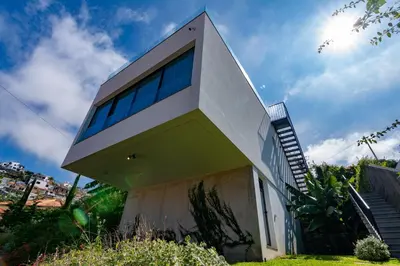 a modern house with a green and white facade at Villa Mármore in Funchal