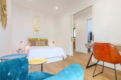 a bedroom with a bed and two chairs at Villa Mármore in Funchal