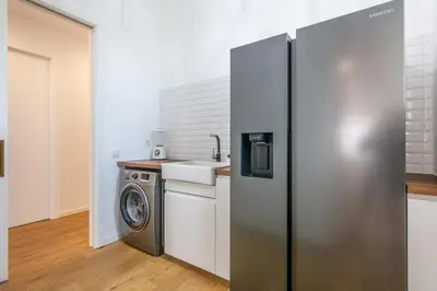 a kitchen with a refrigerator and a washing machine at Villa Mármore in Funchal