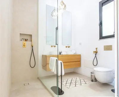 a bathroom with a glass shower and a toilet at Villa Mármore in Funchal
