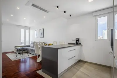 a kitchen and living room with white walls at Lido Sunrise Apartment by Homie in Funchal