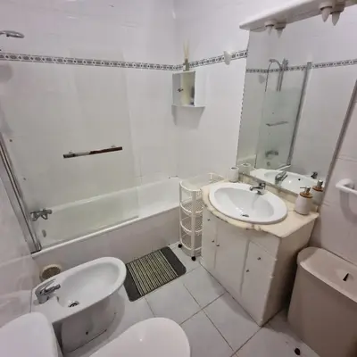 a bathroom with a sink and a toilet and a tub at Ina's Garden in Santa Cruz in Santa Cruz