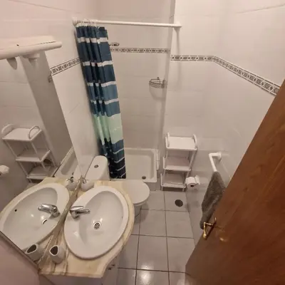 a bathroom with a sink and a toilet at Ina's Garden in Santa Cruz in Santa Cruz