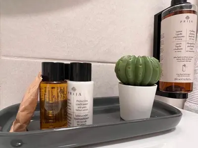 a tray with three bottles of essential oils and a cactus at Oásis de verão- 2 bedrooms flat with swimming pool in Sagres