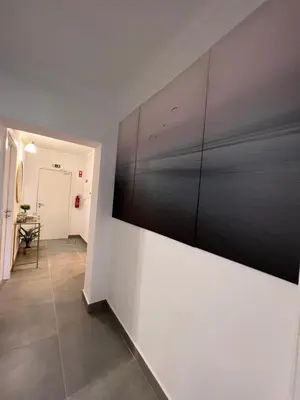 a hallway with a large painting on a wall at Oásis de verão- 2 bedrooms flat with swimming pool in Sagres