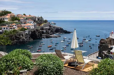 a view of a harbor with boats in the water at Casa Mar Adentro in Câmara de Lobos