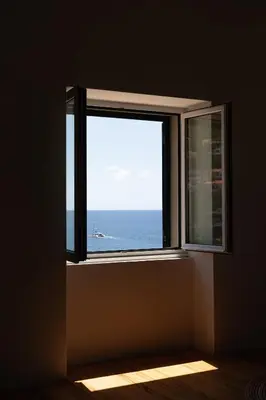 a walk in closet with white cabinets and a stool at Casa Mar Adentro in Câmara de Lobos