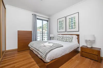 a white bedroom with a bed and a window at Blue and Gold Sunset by Homie in Funchal