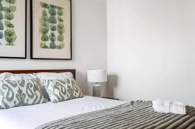 a bedroom with a bed and two pictures on the wall at Blue and Gold Sunset by Homie in Funchal