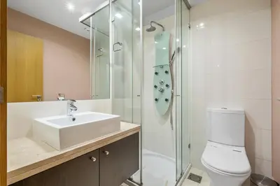 a bathroom with a sink and a shower and a toilet at Blue and Gold Sunset by Homie in Funchal