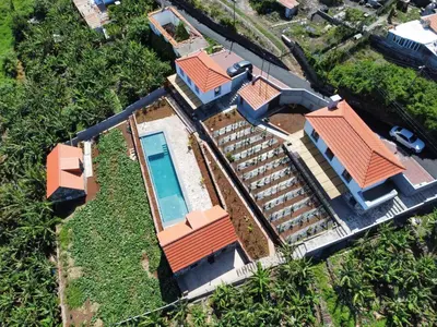 an aerial view of a house with a swimming pool at CASAS DO LARANJO- Cottages & Infinity Pool in Gaula
