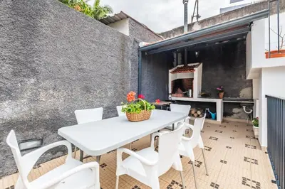 an outdoor patio with a white table and chairs at Casa do Pina in Funchal