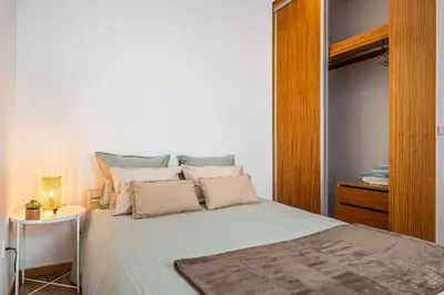 a bedroom with a large bed with a night stand at Casa do Pina in Funchal