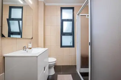 a bathroom with a toilet and a sink and a mirror at Casa do Pina in Funchal