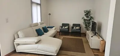a living room with a white couch and blue pillows at Casa do Pina in Funchal