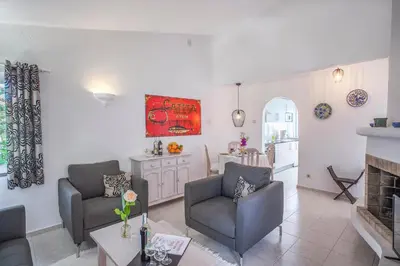 a living room with a table and chairs on a balcony at Garden T2 Apartment in Luz in Luz